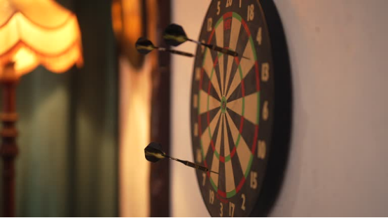 Player practicing low-noise throwing technique on a quiet dart board
