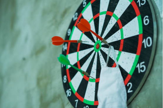 Dart board practice setup, focusing on hand-eye coordination for both hands.