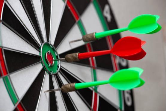 Dart player targeting a triple on a dart board