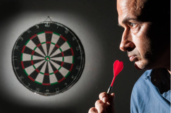 Advanced player analyzing dart board feedback during practice