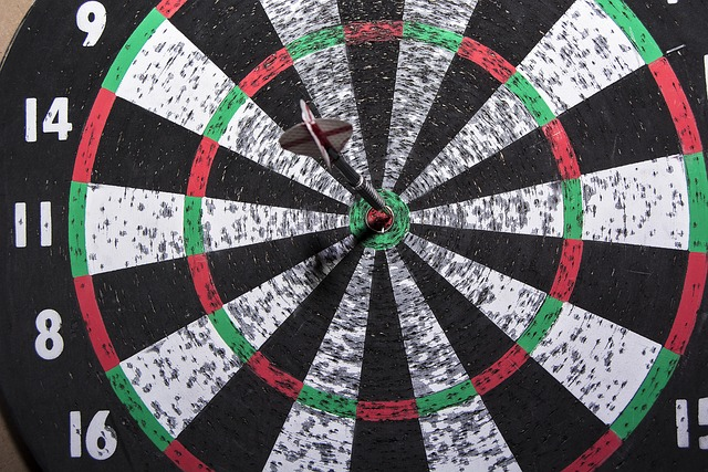A dart board with one dart scoring a bullseye in a detailed shot.
