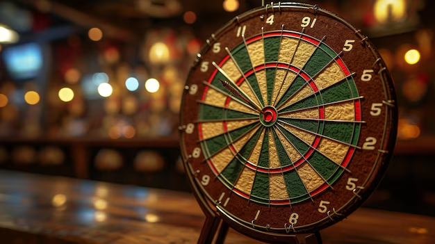 Close-up of a dart board with a dart in the bullseye, standing on a bar table.